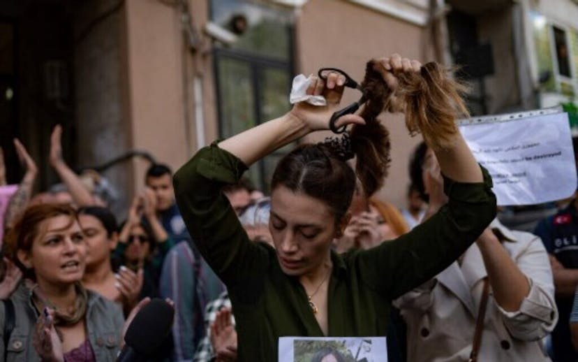 A Woman in Istanbul Cutting Her Hair to Protest the Conditions Women Face in Iran
